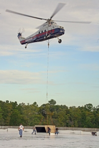 : Aircrane, Inc. S-58T helicopter positioning an air conditioning unit on                                top of a building in Palm Coast, Florida. (Picture from www.aircrane.com )