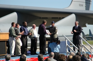 Lt Col J.C. Clemons (in flight suit), aircraft commander for the final flight from Robins, accepts the AFTO 781 aircraft maintenance forms as the final official act before departure.